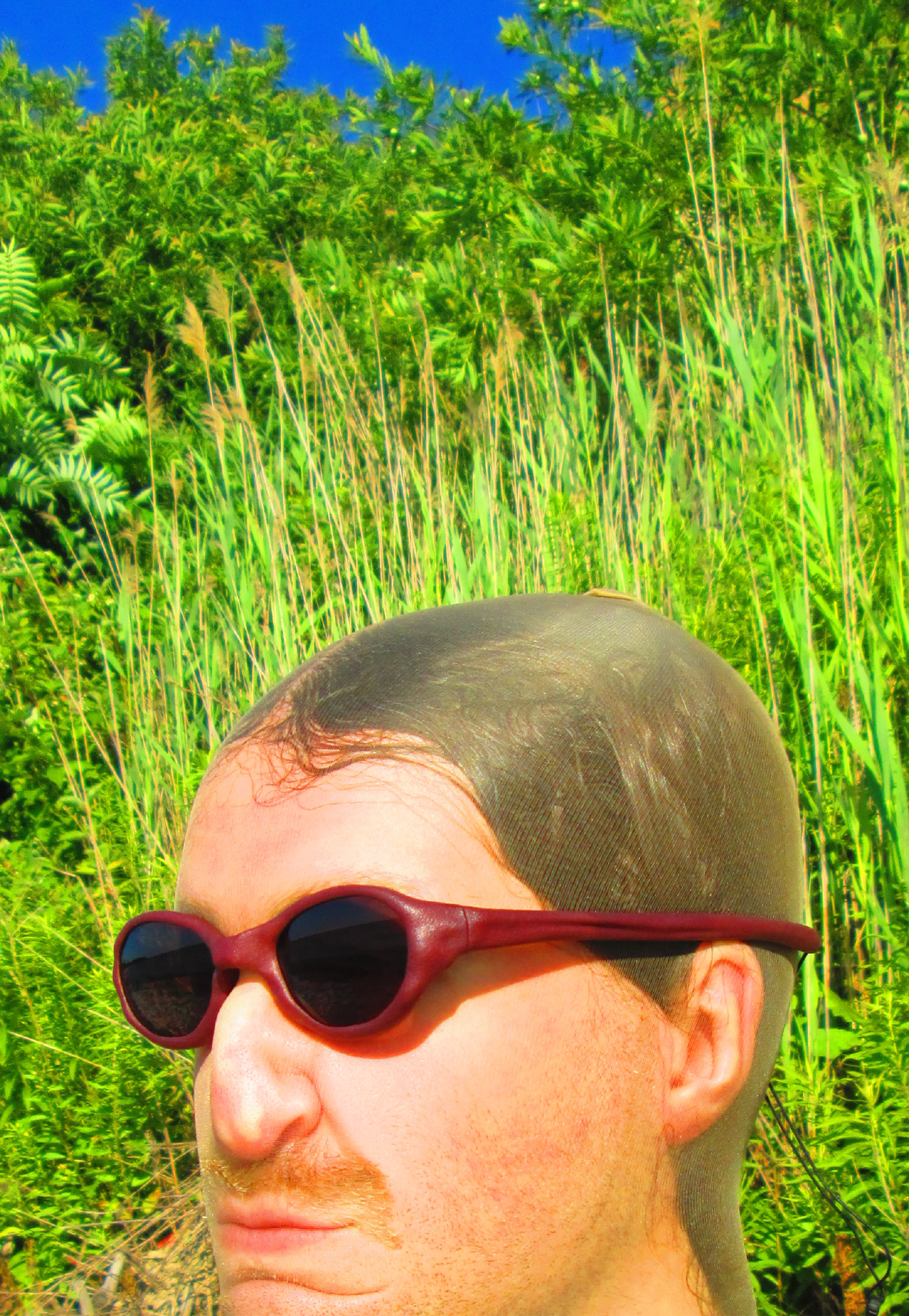 3D render of a bald model wearing black sunglasses with transparent grey lenses